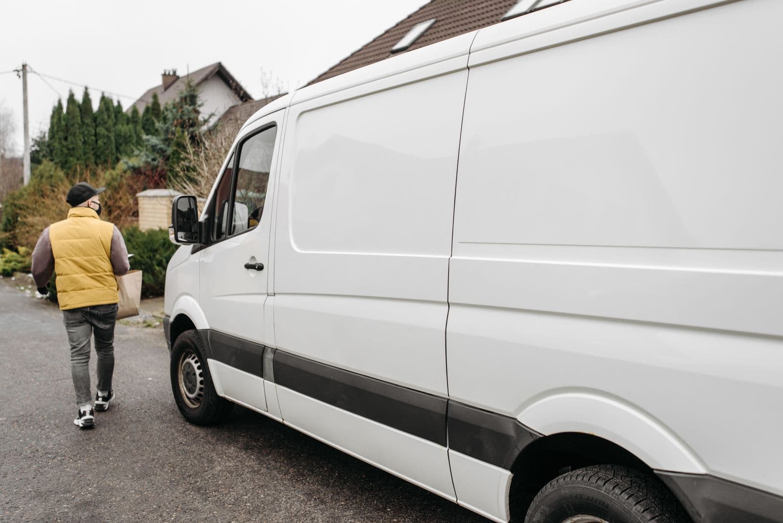 Right Choice Logistics courier carrying a parcel from the delivery van to the door